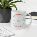 Do better white glossy mug with colorful circle design on office desk with plant and books
