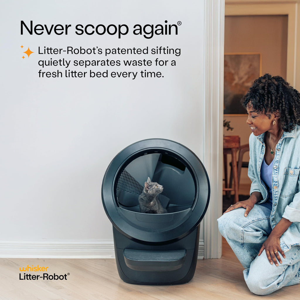 Whisker Litter-Robot with cat and smiling owner beside unit in home interior Litter-Robot 4 supply bundle