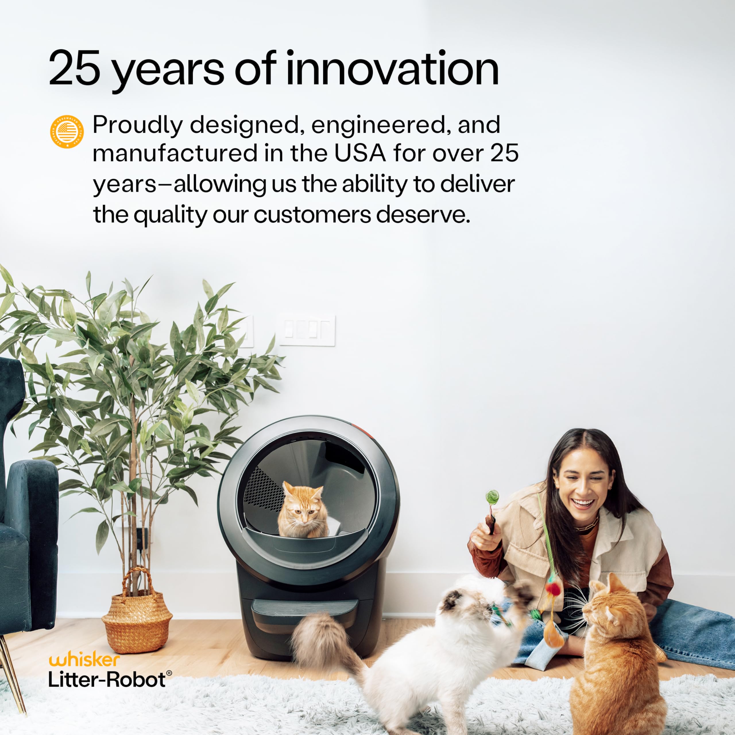 Whisker Litter-Robot with three playful cats and owner in living room showcasing Litter-Robot 4 supply bundle